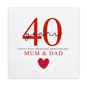 May include: A white card with red text and a knitted red heart. The card reads "40 years" in large red numbers, with "years" in a script font. Below, it says "Happy Ruby Wedding Anniversary Mum & Dad."