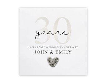 May include: A white card with the text "30 years" in a script font. Below, it reads "Happy Pearl Wedding Anniversary" and the names "John & Emily." A small, textured heart is at the bottom. A perfect gift for a 30th wedding anniversary.