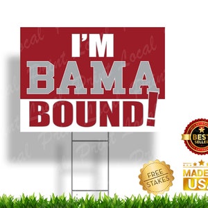 May include: A red and white yard sign with the text "I'M BAMA BOUND!" in white and gray lettering. The sign is on a metal stake and has a "Best Seller" and "Made in USA" badge.