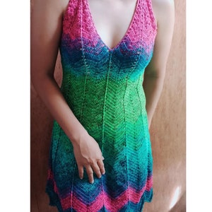 May include: A sleeveless crochet dress with a V-neckline and a gradient pattern of pink, green and blue.