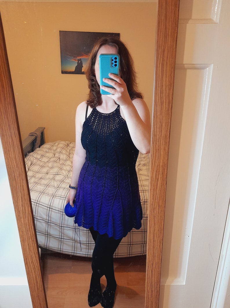 May include: A blue and black ombre crochet dress with a scalloped hemline.