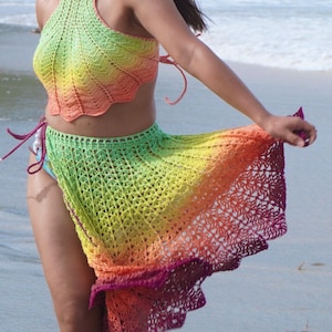 May include: A rainbow crochet top and skirt set. The top is halter style and the skirt is long and flowing. The colors are green, yellow, orange, and red.