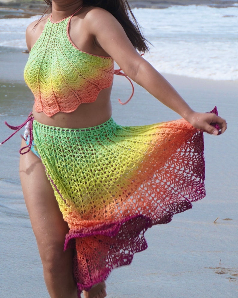 May include: A rainbow crochet top and skirt set. The top is halter style and the skirt is long and flowing. The colors are green, yellow, orange, and red.