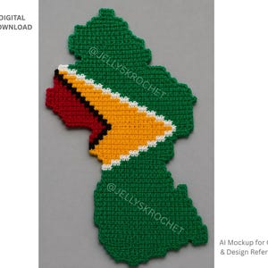 May include: A crochet piece shaped like the map of Guyana, featuring a green base with a central design of a red triangle, a black border, and a yellow triangle with a white border. The text DIGITAL DOWNLOAD and AI Mockup for Color & Design Reference appear.