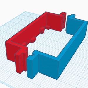 Puede incluir: Un modelo 3D de un marco de plástico rojo y azul. El marco está formado por dos piezas que encajan para formar una forma rectangular.