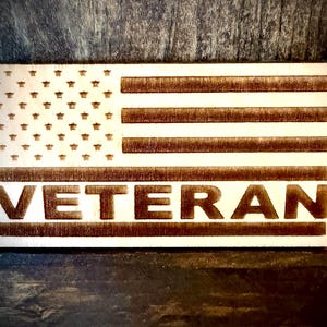 Veteran laser engraved US Flag refrigerator magnet.  1/4 inch thick wood.  4 inches X 2.1 inches.  Great gift to show pride.
