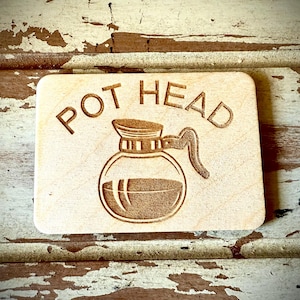 May include: A wooden sign with the text "POT HEAD" and a graphic of a coffee pot.