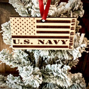 US Navy Proud Dad laser engraved US flag ornament.  1/4 inch wood.  4 inches X 2.1 inches.  Great gift to show pride!