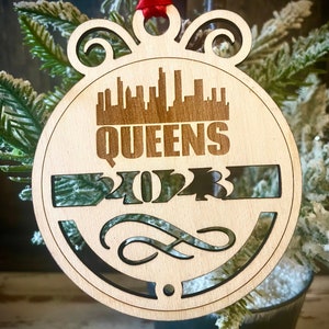 Ornament - Queens Skyline cityscape. 4&quot; X 4.75&quot; wood ornament with choice of year.  Great souvenir or memento from your favorite city.