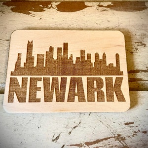 Magnet - Newark Skyline cityscape. 3.5" X 2.5" wood magnet.  Great souvenir or memento from your favorite city.