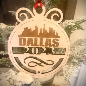 Ornament - Dallas Skyline cityscape. 4&quot; X 4.75&quot; wood ornament with choice of year.  Great souvenir or memento from your favorite city