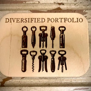 May include: A wooden plaque with the text "Diversified Portfolio" and a collection of nine different bottle openers and corkscrews.