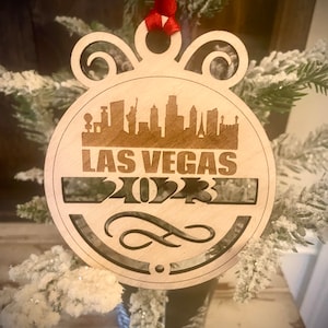 Ornament - Las Vegas Skyline cityscape. 4&quot; X 4.75&quot; wood ornament with choice of year.  Great souvenir or memento from your favorite city.
