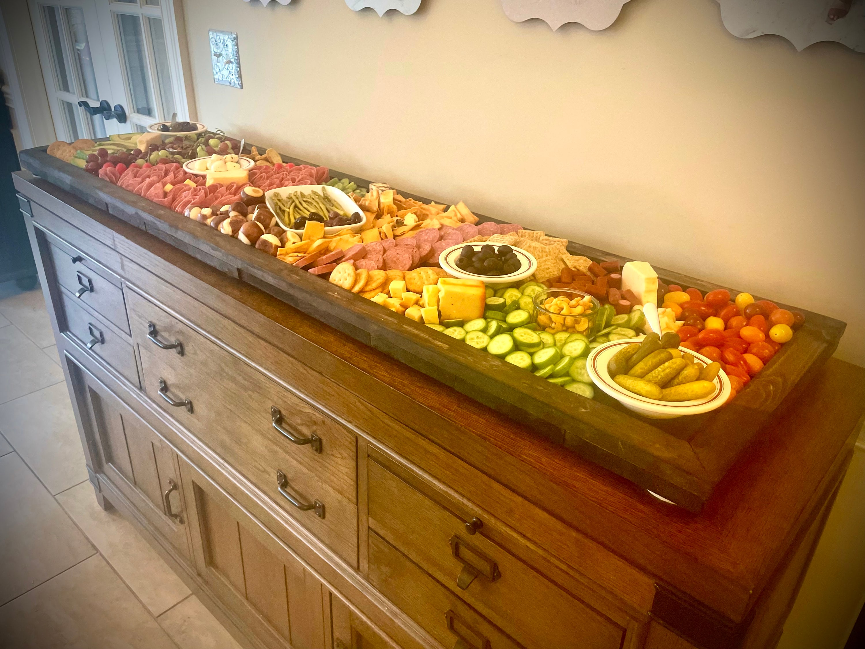 Farmhouse style custom rustic distressed charcuterie boards / serving trays with raised edges and optional engraving and handles.