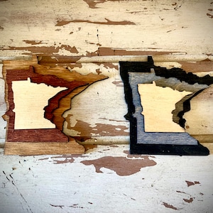 Minnesota 3-layer stacked state laser cut wood magnet available in brown tones or gray tones.
