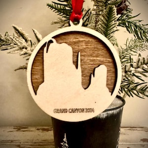 Grand Canyon scene with rock formations 2-layer personalized laser cut wood Christmas ornament, gift tag available in 12 finishes.