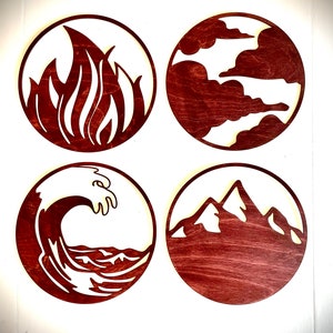 May include: Four round wooden plaques with different symbols cut out. The symbols are a flame, clouds, a wave, and mountains. The plaques are stained a dark reddish brown color.