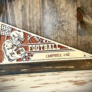 Personalized Custom Male Football Player Wood 2-layer pennant with player name and number engraved-available in 12 finishes.  Pose 2 of 2