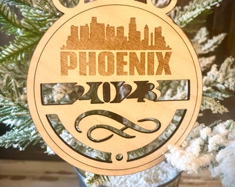 Ornament - Phoenix Skyline cityscape. 4" X 4.75" wood ornament with choice of year.  Great souvenir or memento from your favorite city.