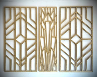 May include: Three gold-colored geometric wall panels with a repeating pattern of lines and shapes. The panels are made of wood and have a modern design.
