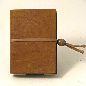 Aged leather notebook with recycled straw paper