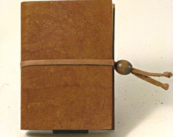 Aged leather notebook with recycled straw paper