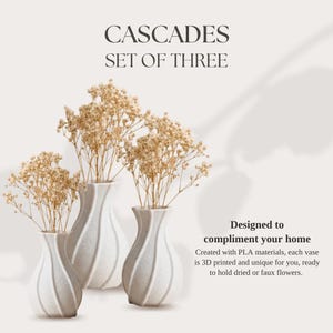 May include: A set of three white speckled vases with a spiraled, ribbed texture, each containing dried beige flowers. The text reads: CASCADES SET OF THREE. Designed to compliment your home. Created with PLA materials, each vase is 3D printed.