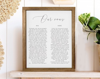 May include: A framed print with the words "Our Vows" at the top. The print contains vows written for a wedding ceremony. The vows are written in black ink on a white background. The frame is brown wood.