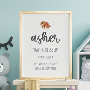 May include: A nursery print with a wooden frame featuring a cartoon dinosaur and the name "asher" in cursive. The print also includes the text "Happy, Blessed", "Origin: Hebrew", "Adventurous, Reliable, Efficient, Honorable".