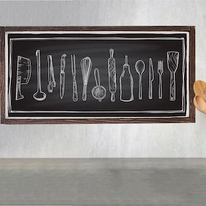 May include: A framed chalkboard with a white drawing of various kitchen utensils, including a rolling pin, a whisk, a spatula, a ladle, a knife, a fork, and a spoon. A white ceramic utensil holder with gold polka dots holds a variety of wooden kitchen utensils.