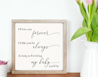 May include: A framed sign with a white background and black text that reads "I'll love you forever, I'll like you for always, As long as I'm living my baby you'll be."