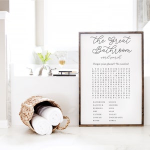Puede incluir: Un letrero de madera marr&oacute;n con el texto "The Great Bathroom Word Search" y un crucigrama con las palabras "bathroom", "bathtub", "bubbles", "dry", "lather", "loofah", "rinse", "scrub", "shower", "sink", "soap", "toilet", "toothpaste", "towel".