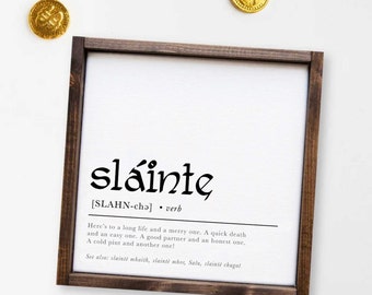 May include: A framed print with a white background and black text. The text reads "sláinte [SLAHN-chǝ] • verb Here's to a long life and a merry one. A quick death and an easy one. A good partner and an honest one. A cold pint and another one! See also: slaintè mhaith, slaintè mhor, Salu, slaintè chugat"