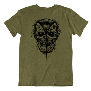 May include: A green t-shirt with a black and white graphic print of a skull with a split face.
