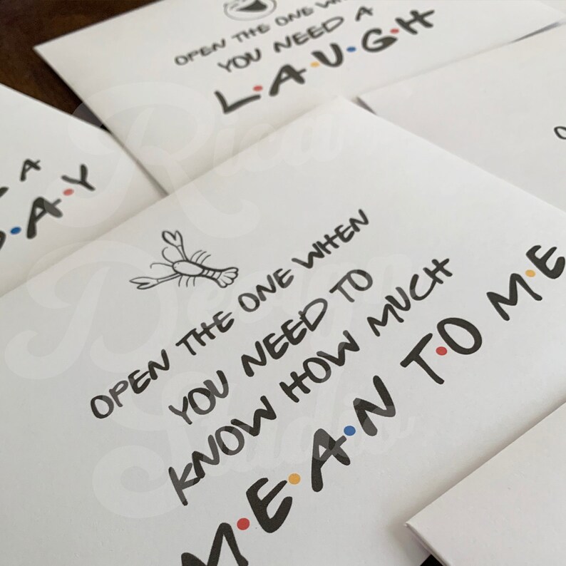 May include: White card with black text that reads "Open the one when you need to know how much I mean to you". A small black and white illustration of a lobster is above the text.