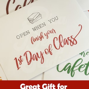 May include: A white card with red text that reads "OPEN WHEN YOU FINISH YOUR 1ST DAY OF CLASS". The card features a stack of books and is a great gift for college students.