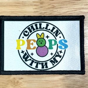 May include: A black and white patch with a colorful circle design. The circle says "Chillin' with my Peeps" with a cartoon Peep in the center.