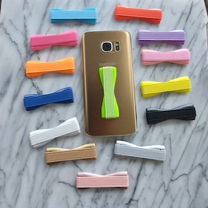 May include: A set of three ceramic mugs with a speckled, matte finish. The mugs are in shades of cream, light gray, and dark gray. Each mug has a simple, minimalist design, perfect for coffee or tea.