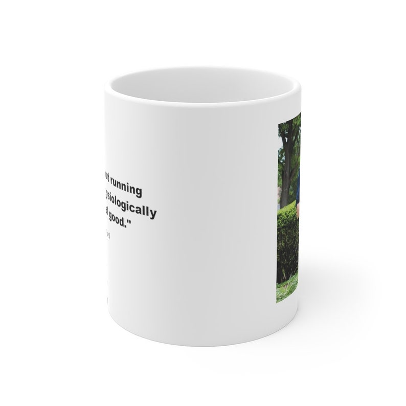May include: White ceramic mug with a black quote that reads "Running is biologically good." and a photo of a person running in a park.