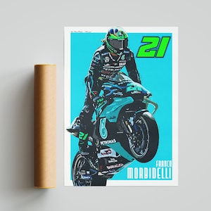May include: A digital illustration of a motorcycle racer wearing a green and black helmet and a blue, green and white racing suit. The racer is riding a blue and white motorcycle with the number 21 on the side. The background is a light blue colour. The text "FRANCO MORBIDELLI" is printed below the motorcycle.
