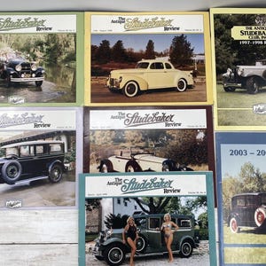 Könnte beinhalten: Eine Sammlung von acht Vintage-Magazinen mit klassischen Studebaker-Automobilen. Die Magazine sind betitelt mit "The Antique Studebaker Review" und "The Antique Studebaker Club, Inc. 1997-1998 Roster" und "2003-2004 Roster".