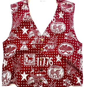 May include: A red sleeveless vest with a white star pattern and various white images of eagles, cannons, and horses. The vest has the text "1776" and "Hoosier's Livery" printed on it.