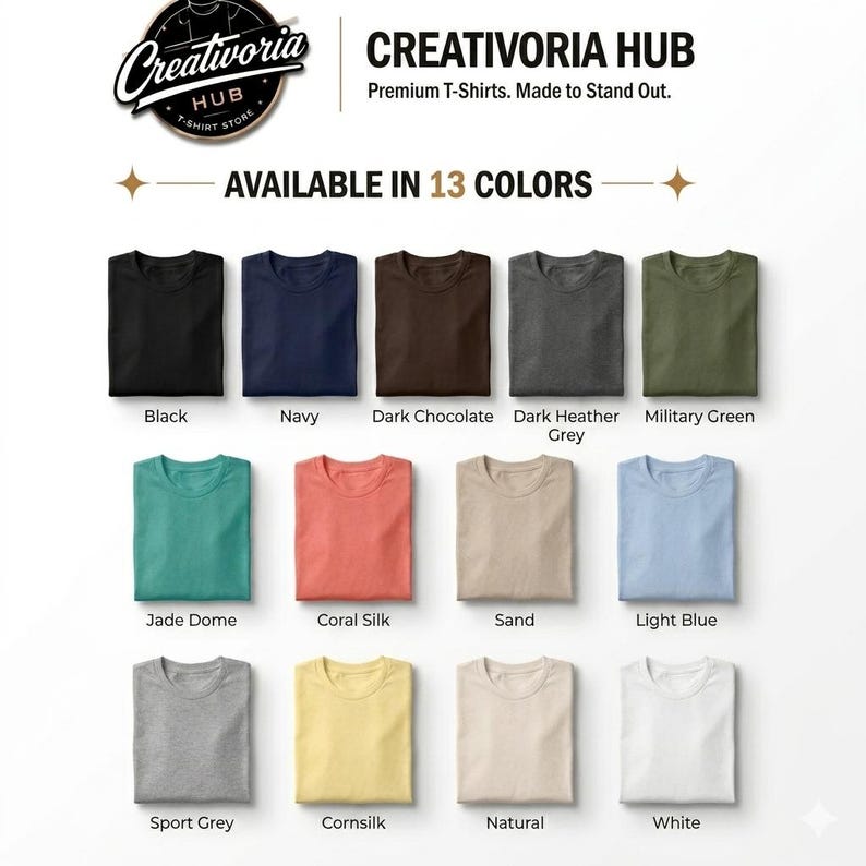 May include: A display of folded t-shirts in various colors, including black, navy, and military green. The text "Creativoria Hub" and "Available in 13 Colors" is visible. The shirts are arranged neatly, showcasing a range of hues.