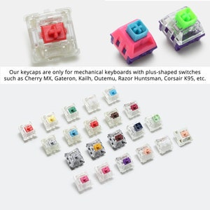 May include: A collection of colorful mechanical keyboard keycaps. The keycaps are various colors, including red, pink, blue, green, and purple. The text in the image says, "Our keycaps are only for mechanical keyboards with plus-shaped switches such as Cherry MX, Gateron, Kailh, Outemu, Razor Huntsman, Corsair K95, etc."