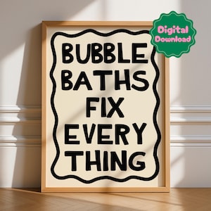 May include: A framed print with the text "BUBBLE BATHS FIX EVERYTHING" in black, set against a cream background. The text is enclosed in a wavy black border. A green digital download sticker is in the upper right corner.