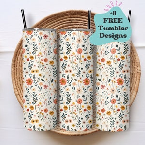 May include: Three stainless steel tumblers with a floral pattern in shades of orange, yellow, and pink on a white background. The tumblers are sitting in a woven basket. The text '+8 FREE Tumbler Designs' is in a speech bubble above the tumblers.