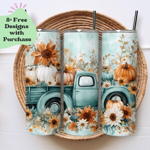 May include: Three turquoise tumblers with a fall-themed design featuring a vintage truck carrying pumpkins and sunflowers. The tumblers are displayed on a woven basket.