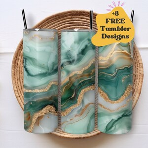 May include: Three stainless steel tumblers with green and gold marble designs. The tumblers are sitting on a woven basket. The text '+8 FREE Tumbler Designs' is in a yellow speech bubble.