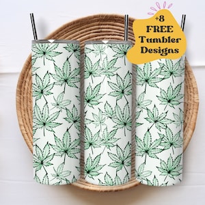 May include: Three stainless steel tumblers with a white background and a green marijuana leaf pattern. The tumblers are sitting on a woven basket.