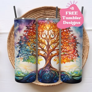 May include: Three stainless steel tumblers with a colorful tree of life design. The tree features a vibrant watercolor style with hues of blue, orange, and purple. Each tumbler has a black straw and is displayed in a woven basket.